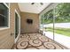 Cozy screened porch with a TV and decorative rug, perfect for outdoor entertainment at 100 Pronghorn Deer Ct, Garner, NC 27529