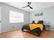 Comfortable bedroom with hardwood floors, ceiling fan, and coordinated bedding at 1002 Willow Dr # Apt 107, Chapel Hill, NC 27514