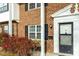 Two-story brick townhome exterior with black shutters at 1002 Willow Dr # Apt 107, Chapel Hill, NC 27514