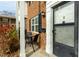 Charming townhome exterior with brick facade and outdoor seating area at 1002 Willow Dr # Apt 107, Chapel Hill, NC 27514