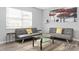 Bright living room with two gray sofas, glass coffee table, and large window at 1002 Willow Dr # Apt 107, Chapel Hill, NC 27514