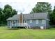 Spacious backyard with deck, fenced in yard, and a view of the rear of the home at 1008 Catsby Cir, Raleigh, NC 27603