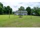 Spacious backyard with a fire pit and view of the rear of the home with a fenced in yard at 1008 Catsby Cir, Raleigh, NC 27603