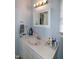 Well-lit bathroom vanity with white countertop and framed mirror, offering ample storage space at 1008 Catsby Cir, Raleigh, NC 27603