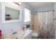 Neat bathroom with a vanity, toilet, and a shower with decorative curtain at 1008 Catsby Cir, Raleigh, NC 27603