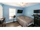 Well-lit bedroom with a ceiling fan, TV, and minimalist decor at 1008 Catsby Cir, Raleigh, NC 27603