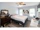 Light-filled bedroom featuring a dark wood dresser, light gray walls and wood look floors at 1008 Catsby Cir, Raleigh, NC 27603