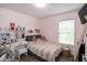 Charming bedroom featuring a cozy bed, a vanity table, and pink walls at 1008 Catsby Cir, Raleigh, NC 27603