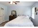 Light-filled bedroom features a dark wood dresser, light gray walls and wood look floors at 1008 Catsby Cir, Raleigh, NC 27603