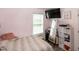 Inviting bedroom with a large window, TV, ample storage, and light pink walls at 1008 Catsby Cir, Raleigh, NC 27603