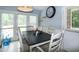 Inviting dining area features large windows, a dark-wood table, and seating for six, perfect for Gathering meals at 1008 Catsby Cir, Raleigh, NC 27603
