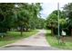 Long driveway leading to a charming home with lush landscaping and mature trees at 1008 Catsby Cir, Raleigh, NC 27603