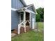 Side entrance with brick steps, white railings, and access to a fenced yard at 1008 Catsby Cir, Raleigh, NC 27603