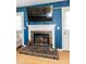 Living room with a stunning fireplace and mantle and a mounted TV at 1008 Catsby Cir, Raleigh, NC 27603