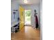 Inviting foyer with a yellow door, coat rack, and shoe storage at 1008 Catsby Cir, Raleigh, NC 27603