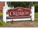 Community sign displaying the name 'Crimson' on a decorative white and maroon sign at 1008 Catsby Cir, Raleigh, NC 27603