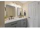 Bright bathroom featuring a double sink vanity with gray cabinets and modern fixtures at 101 Hunter Fld, Sanford, NC 27332