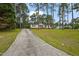 A long driveway leads to this charming home with a spacious front lawn at 101 Hunter Fld, Sanford, NC 27332
