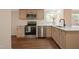Bright kitchen featuring stainless steel appliances, quartz counters and tan cabinets at 101 Hunter Fld, Sanford, NC 27332
