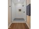 Walk-in shower with white wavy tile and black fixtures, along with a dark herringbone floor at 101 Hunter Fld, Sanford, NC 27332