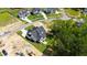 New construction home featuring modern design with a dark roof, situated on a spacious lot in a developing community at 1012 Lily Claire Ln, Fuquay Varina, NC 27526