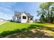 New home has a grassy backyard and covered patio with stairs and a white exterior at 1012 Lily Claire Ln, Fuquay Varina, NC 27526