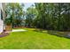 The backyard features a lawn, a small staircase, trees, and landscaping at 1012 Lily Claire Ln, Fuquay Varina, NC 27526