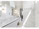 Bright bathroom with white cabinets, marble tile, and gold hardware in the walk-in shower at 1012 Lily Claire Ln, Fuquay Varina, NC 27526
