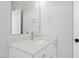 Modern bathroom with a white cabinet, granite countertop, and stainless steel fixtures at 1012 Lily Claire Ln, Fuquay Varina, NC 27526