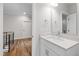 Well-lit bathroom featuring a white vanity with a quartz countertop and modern fixtures at 1012 Lily Claire Ln, Fuquay Varina, NC 27526