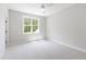Spacious bedroom with plush carpeting, a ceiling fan, and a view from the window at 1012 Lily Claire Ln, Fuquay Varina, NC 27526
