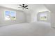 Bright bonus room with carpet, ceiling fan and large windows at 1012 Lily Claire Ln, Fuquay Varina, NC 27526