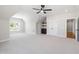 Spacious bonus room with carpet, ceiling fan, built-in shelves, and access to other rooms at 1012 Lily Claire Ln, Fuquay Varina, NC 27526