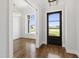 Home's foyer leads to an office with wainscotting, natural light, and beautiful hardwood flooring at 1012 Lily Claire Ln, Fuquay Varina, NC 27526