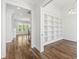 View of the home's foyer, leading to a staircase, with hardwood floors and contemporary railing at 1012 Lily Claire Ln, Fuquay Varina, NC 27526