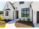 Up close, exterior view of the home's entry and walkway lined with landscaping at 1012 Lily Claire Ln, Fuquay Varina, NC 27526