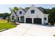 Beautiful new home showcasing a large driveway, two-car garage, and classic architecture with manicured landscaping at 1012 Lily Claire Ln, Fuquay Varina, NC 27526