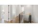 Upstairs hallway with wood floors, metal railing and white doors leading to various rooms at 1012 Lily Claire Ln, Fuquay Varina, NC 27526