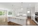 Bright kitchen featuring a large island with white countertops and pendant lighting at 1012 Lily Claire Ln, Fuquay Varina, NC 27526