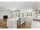 Open-concept kitchen featuring an island, dining area, and living room at 1012 Lily Claire Ln, Fuquay Varina, NC 27526