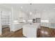Bright kitchen featuring a large island with white countertops and pendant lighting at 1012 Lily Claire Ln, Fuquay Varina, NC 27526