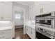 Kitchen features stainless steel oven and microwave appliances with modern white cabinets at 1012 Lily Claire Ln, Fuquay Varina, NC 27526
