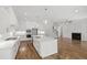 Spacious kitchen open to living room with island, modern appliances, and hardwood floors at 1012 Lily Claire Ln, Fuquay Varina, NC 27526
