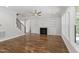 Bright living room featuring a fireplace, built-in shelving, and hardwood floors at 1012 Lily Claire Ln, Fuquay Varina, NC 27526