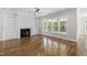 Inviting living room with built-in shelving surrounding a fireplace, and hardwood floors at 1012 Lily Claire Ln, Fuquay Varina, NC 27526