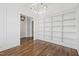 Office boasts custom shelving, a modern light fixture, and beautiful hardwood floors at 1012 Lily Claire Ln, Fuquay Varina, NC 27526