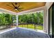 Wide covered patio has a ceiling fan and overlooks the backyard and trees at 1012 Lily Claire Ln, Fuquay Varina, NC 27526