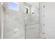 Modern tiled shower featuring glass partition and gold fixtures at 1012 Lily Claire Ln, Fuquay Varina, NC 27526