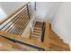 Bright staircase with hardwood steps, wooden banister, and black metal railings at 1012 Lily Claire Ln, Fuquay Varina, NC 27526