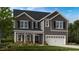 Charming two-story home with gray siding, black shutters, and a two-car garage at 1016 Dillon Lake Dr, Knightdale, NC 27545